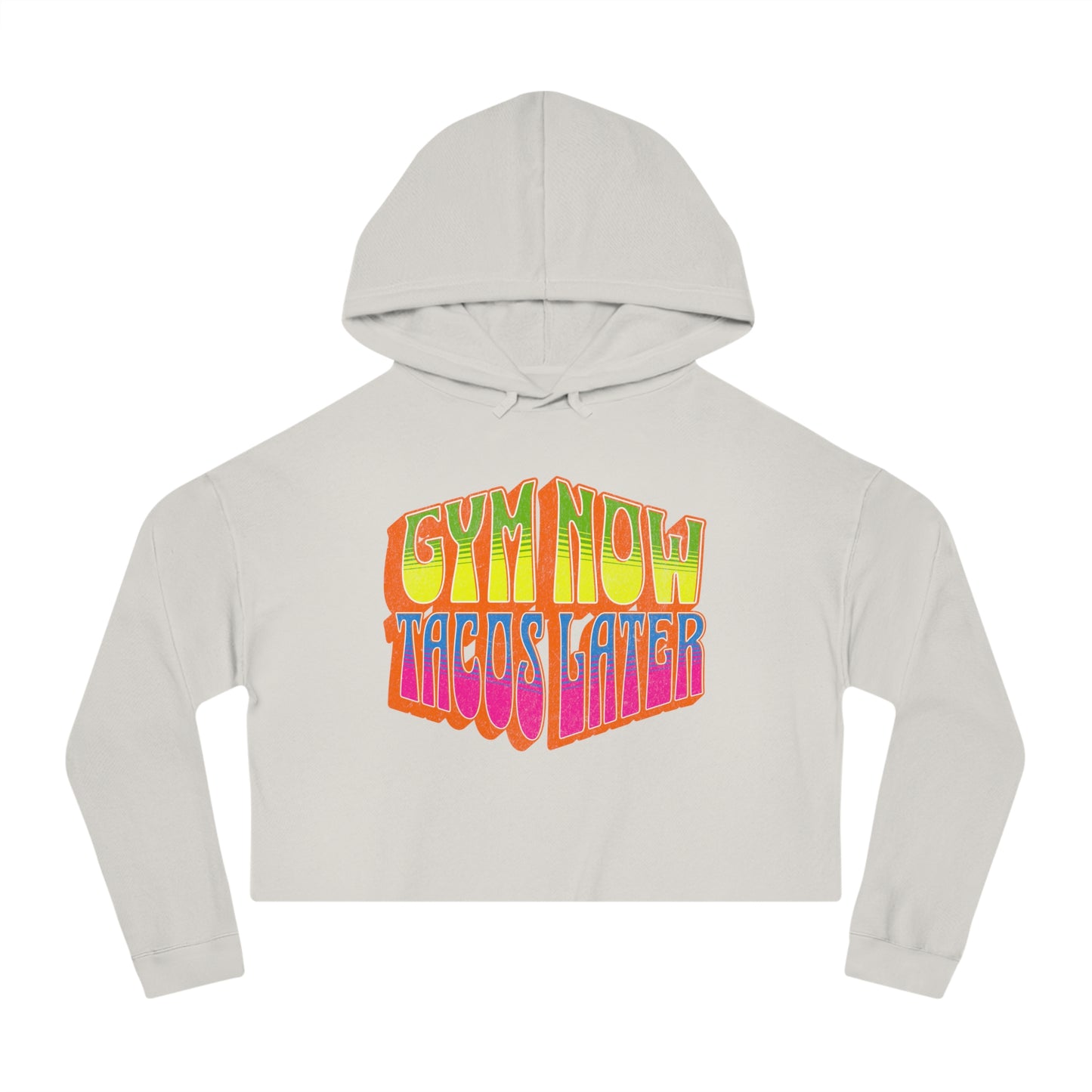 Off-white cropped women's gym hoodie that says GYM NOW, TACOS LATER in bold multicolor lettering.