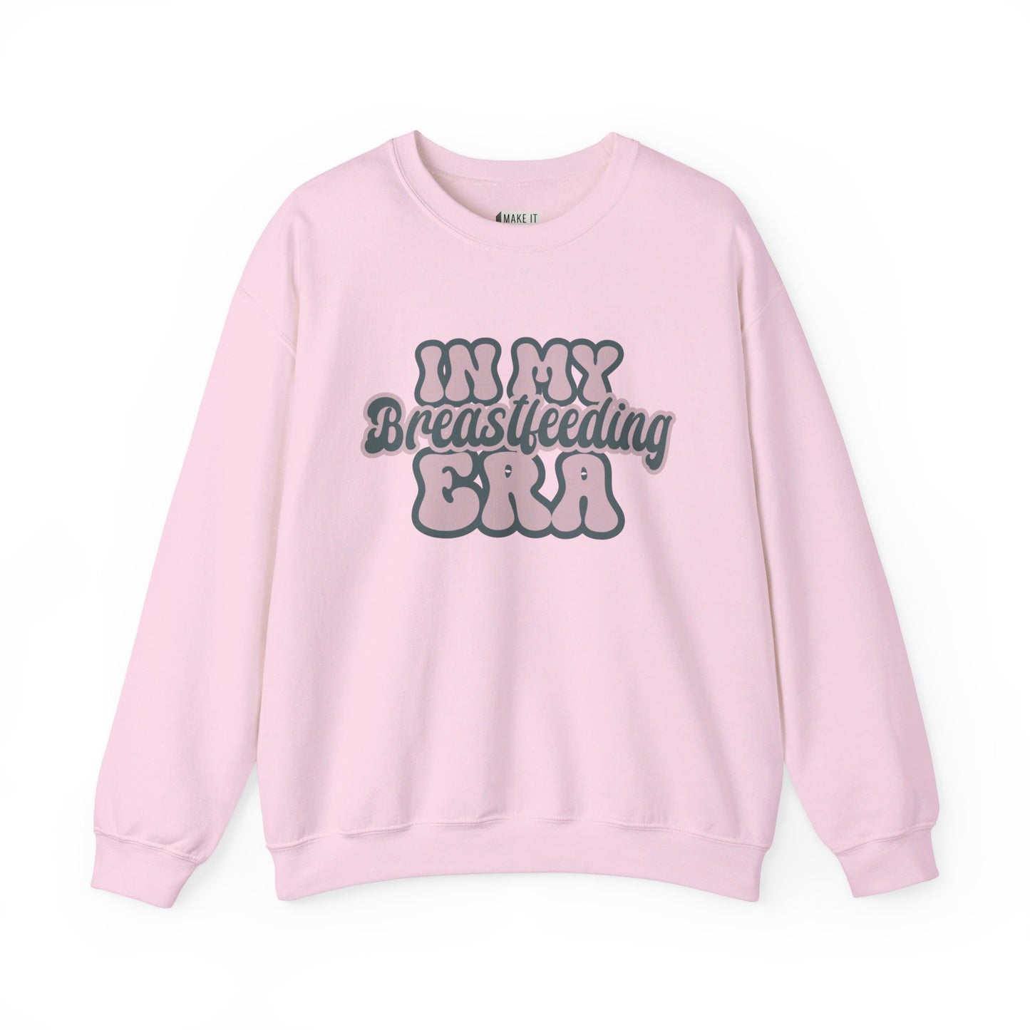 Pink breastfeeding sweatshirt that says IN MY BREASTFEEDING ERA in pink and blue retro lettering.