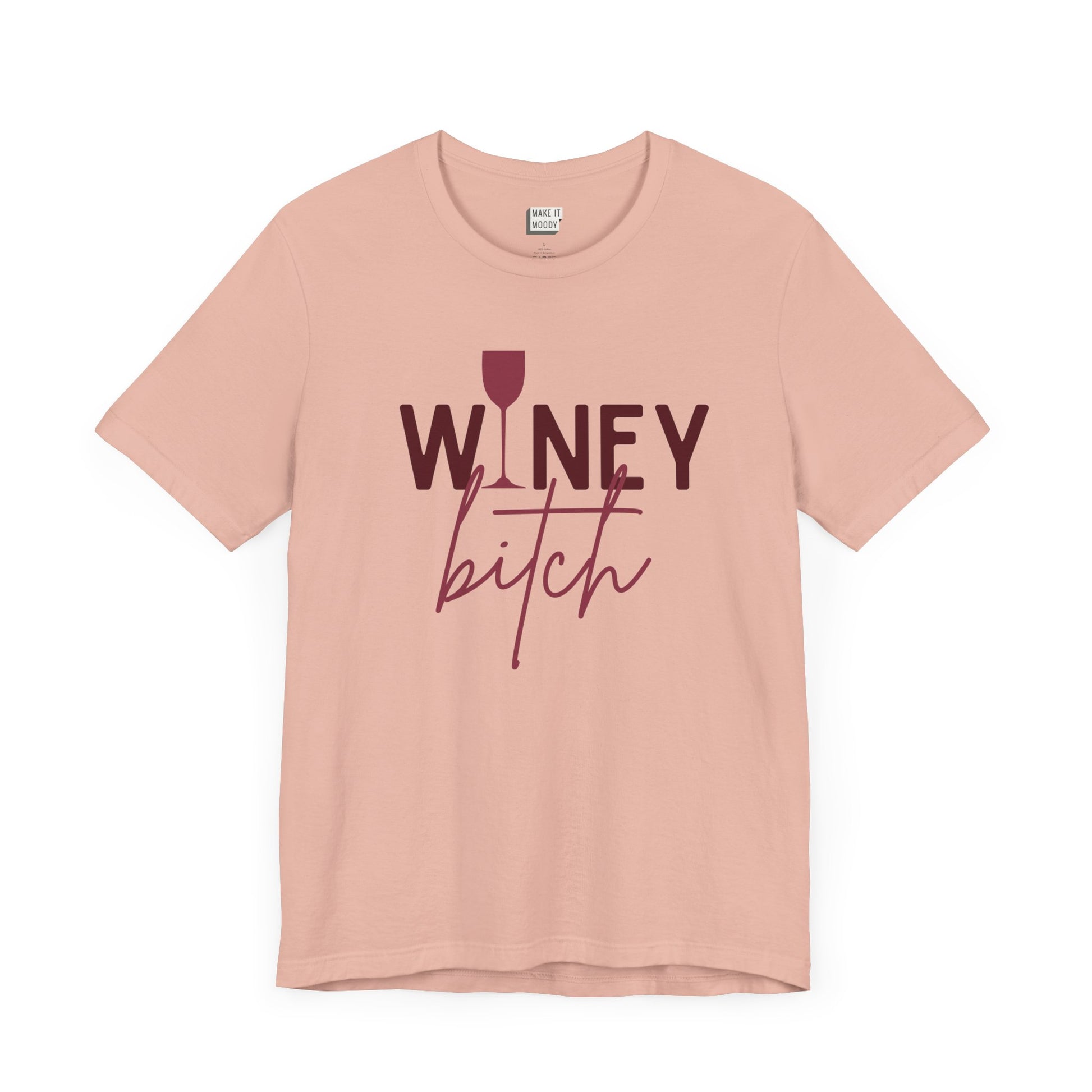 peach colored drinking t-shirt that says WINEY BITCH on the front. There is a graphic of a wine glass in place of the I in the word winey.