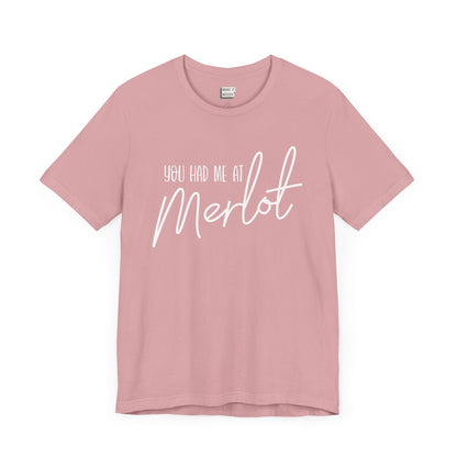 light pink funny drinking t-shirt that says YOU HAD ME AT MERLOT in white lettering