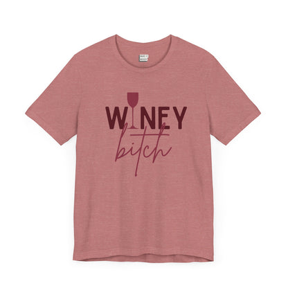 heathered mauve colored drinking t-shirt that says WINEY BITCH on the front. There is a graphic of a wine glass in place of the I in the word winey.