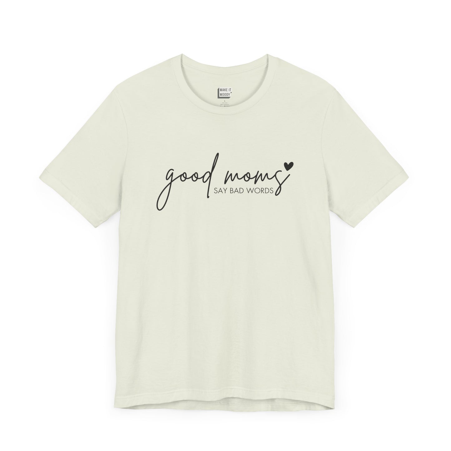 Mom Tee in light green, featuring black cursive and print text with the words good moms SAY BAD WORDS, accented by a small heart.