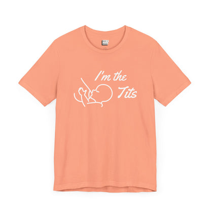 Sunset orange colored breastfeeding t-shirt that says I'm the tits in white print with a minimalist drawing of a baby nursing from a breast.