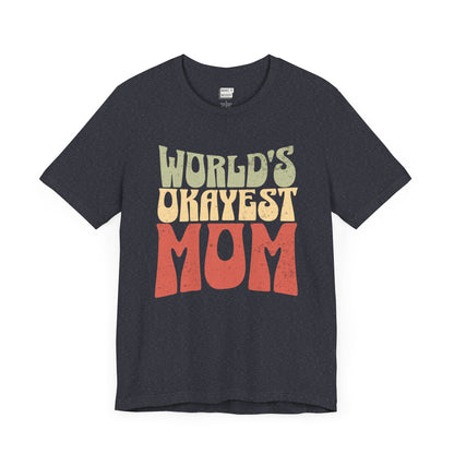 Heather navy mom t-shirt with the text WORLD'S OKAYEST MOM in large retro-style yellow and orange letters on the front.