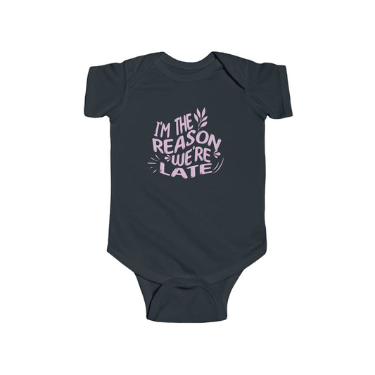 black infant bodysuit that says I'M THE REASON WE'RE LATE in pink wavy lettering on the front.