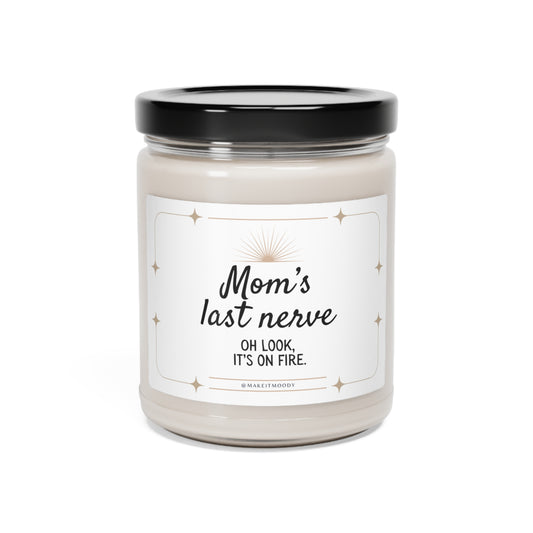 A candle jar labeled "Mom's Last Nerve" Scented Soy Candle, 9oz, with a black lid and white wax inside.