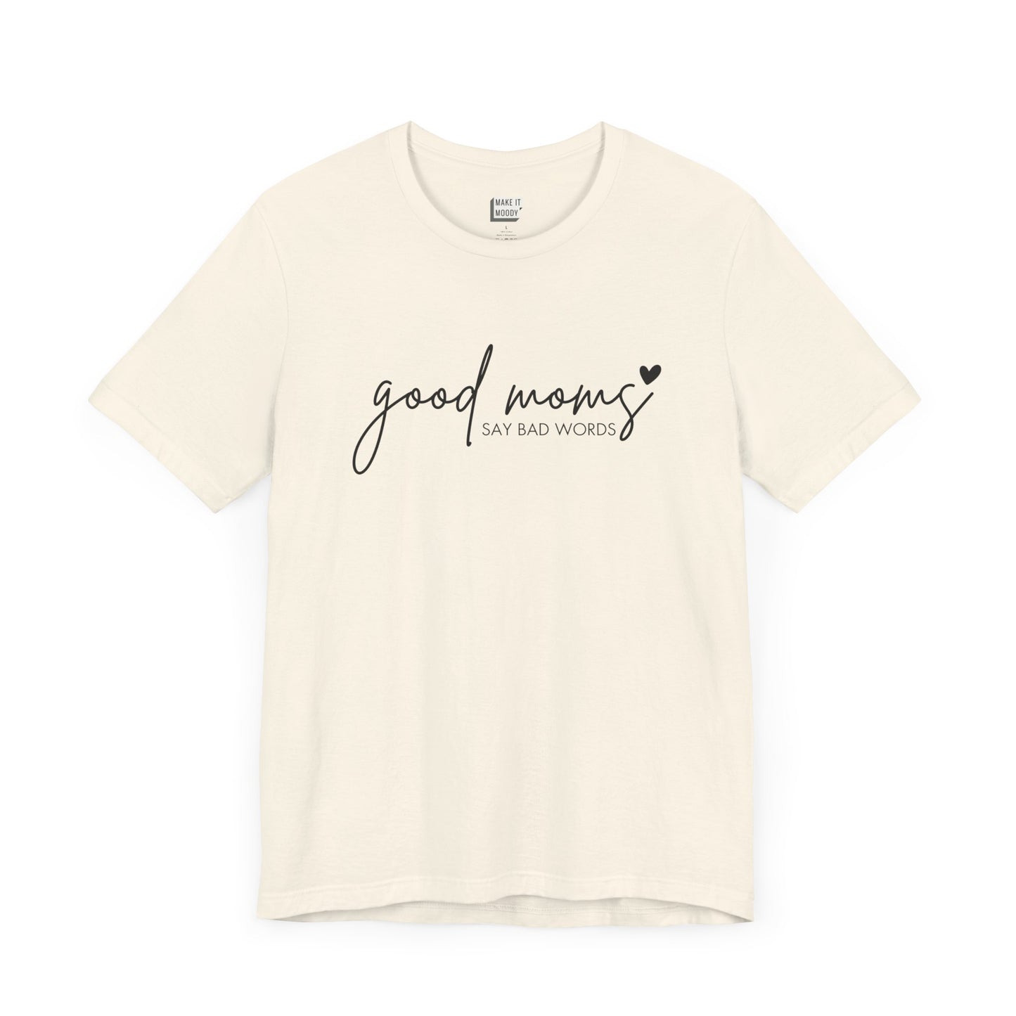 Mom Tee in off-white, featuring black cursive and print text with the words good moms SAY BAD WORDS, accented by a small heart.