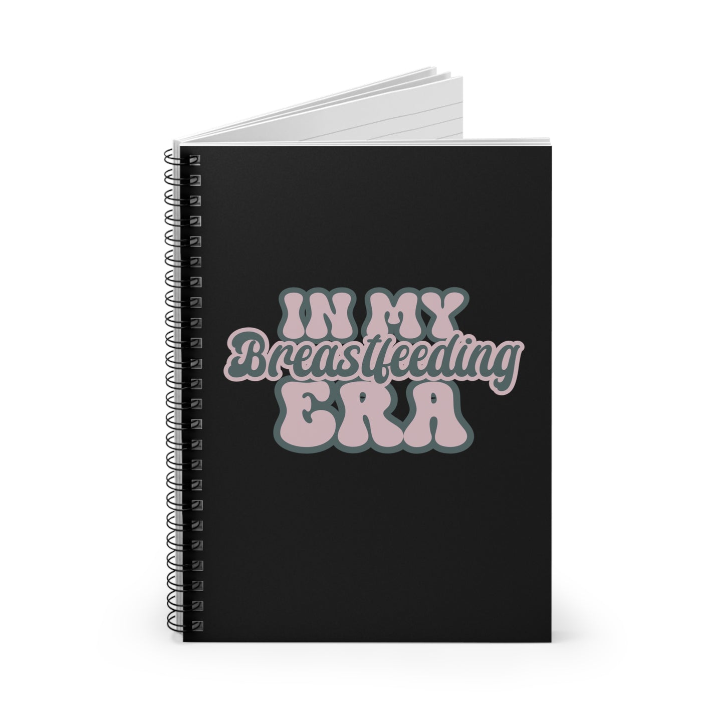 The "In My Breastfeeding Era" Spiral Lined Notebook features a black cover adorned with the phrase "In My Breastfeeding Era" in pink and white bubble letters, making it perfect for use as a breastfeeding notebook or baby feed tracker.