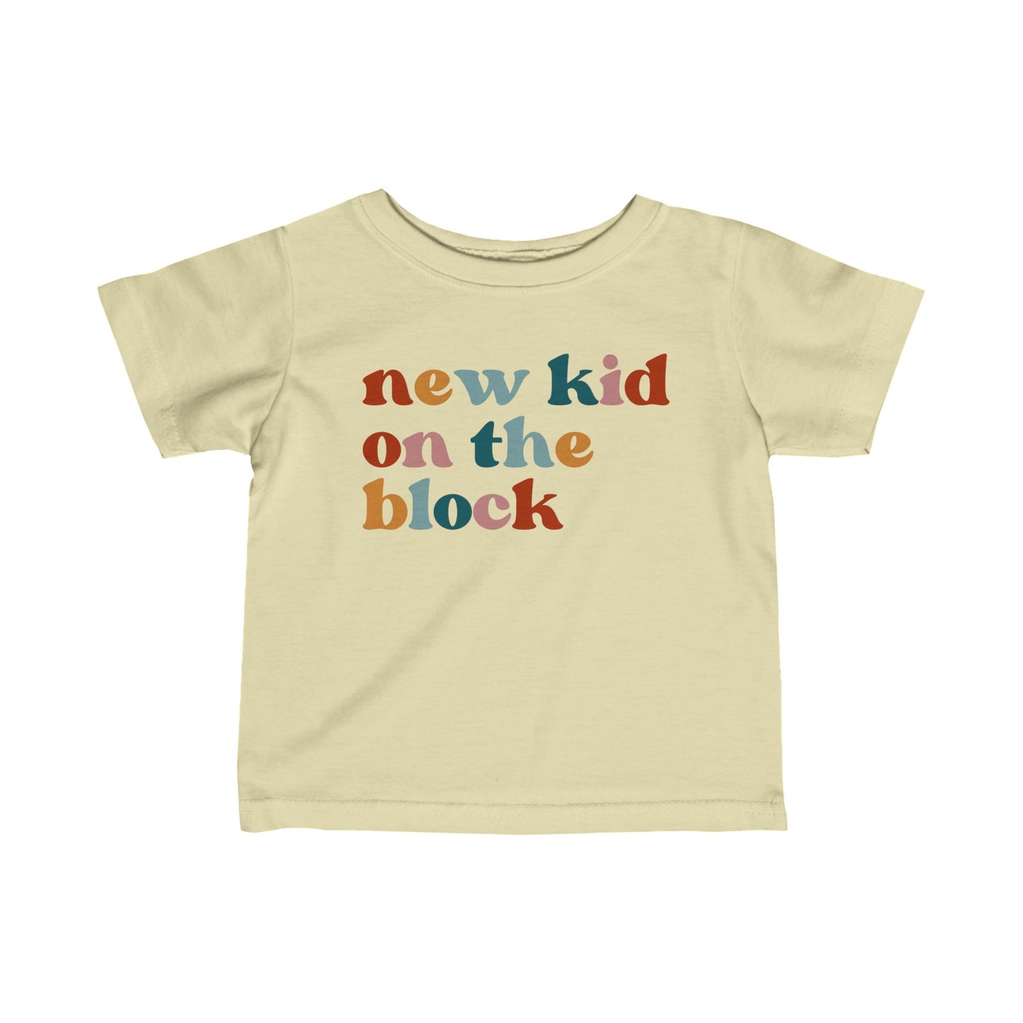 Sand colored t-shirt for babies that says NEW KID ON THE BLOCK in multicolor lettering on the front.