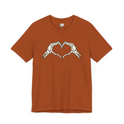 orange shirt with skeleton heart hands on the front