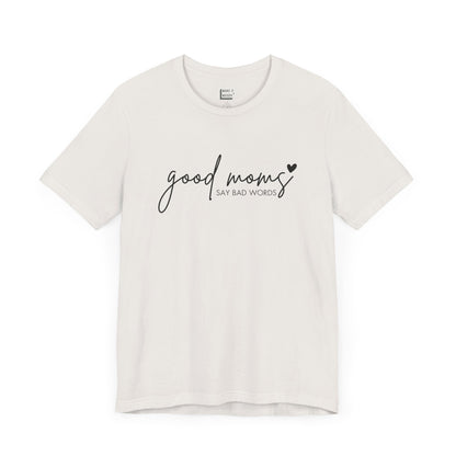 Mom Tee in vintage white, featuring black cursive and print text with the words good moms SAY BAD WORDS, accented by a small heart.