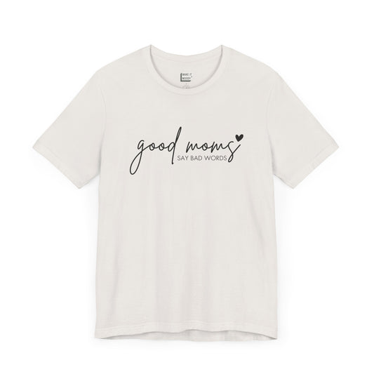 Mom Tee in vintage white, featuring black cursive and print text with the words good moms SAY BAD WORDS, accented by a small heart.