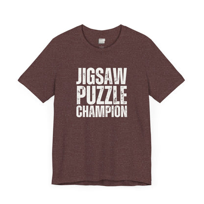 funny graphic t shirt in maroon that says JIGSAW PUZZLE CHAMPION in bold white lettering