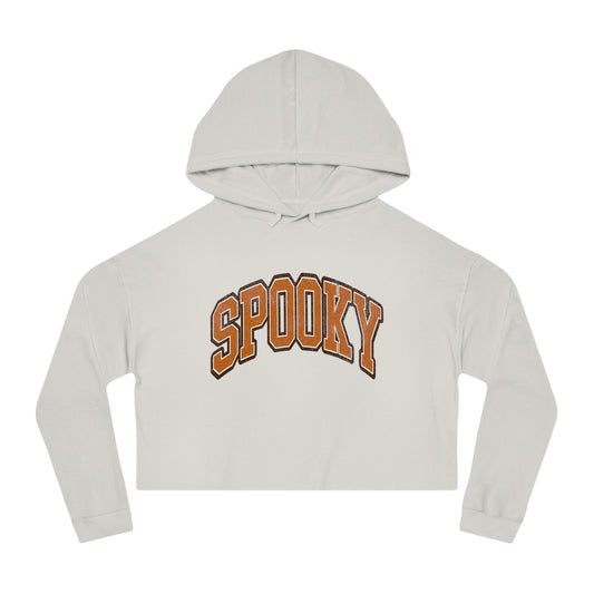 A bone-colored cropped hoodie featuring the word SPOOKY in bold, arched orange letters on the front.