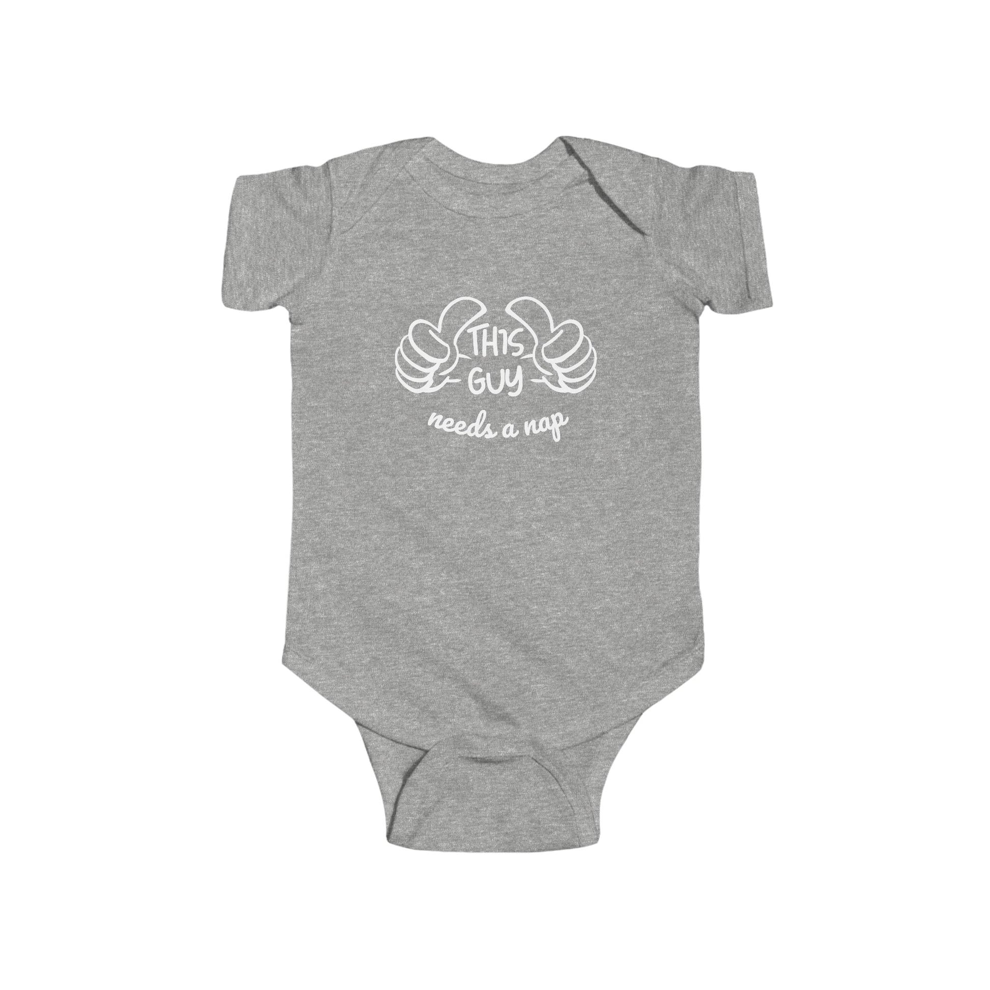 Heather grey infant bodysuit that says THIS GUY NEEDS A NAP in white font with a graphic of 2 thumbs pointing to the wearer of the bodysuit.