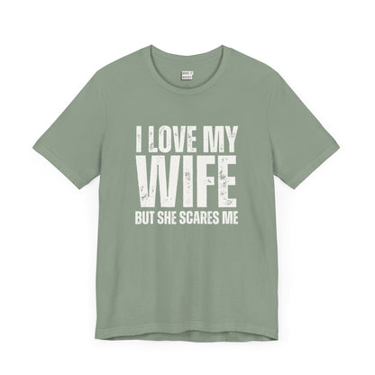 funny t shirt in sage green that says I LOVE MY WIFE BUT SHE SCARES ME in bold white lettering