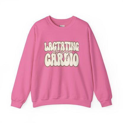 Bright pink funny breastfeeding sweatshirt that says LACTATING IS MY CARDIO in retro lettering.