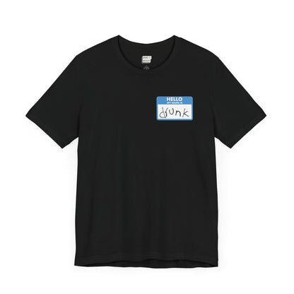 black funny drinking t-shirt with a graphic the resemble and blue sticker name tag on the front in the top left corner. The name tag says HELLO MY NAME IS DRUNK, with the word drunk being handwritten in messy writing.