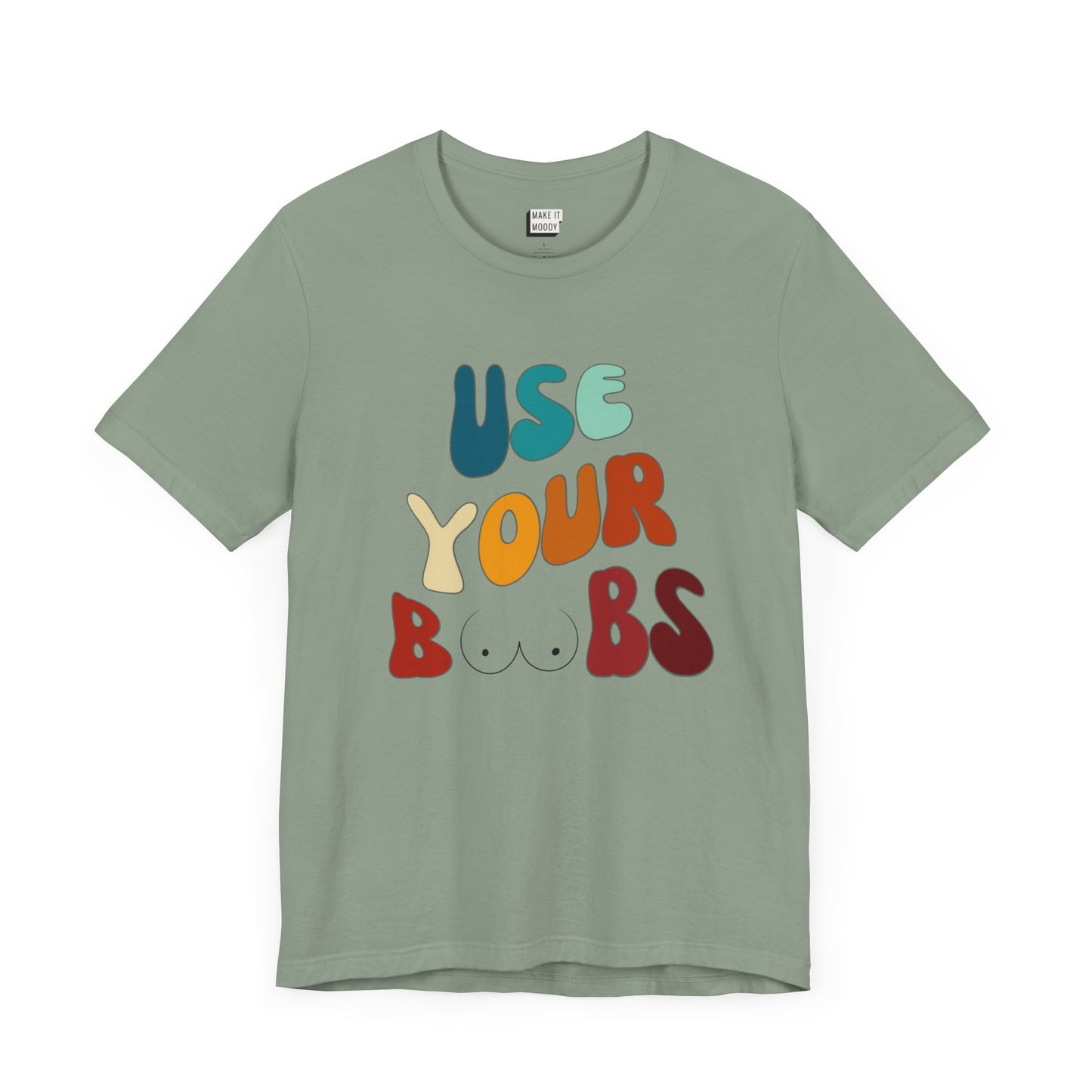 Sage green Breastfeeding T-shirt that says USE YOUR BOOBS in multicolor retro lettering with a minimalistic breast graphic in place of the double O in the word BOOBS.