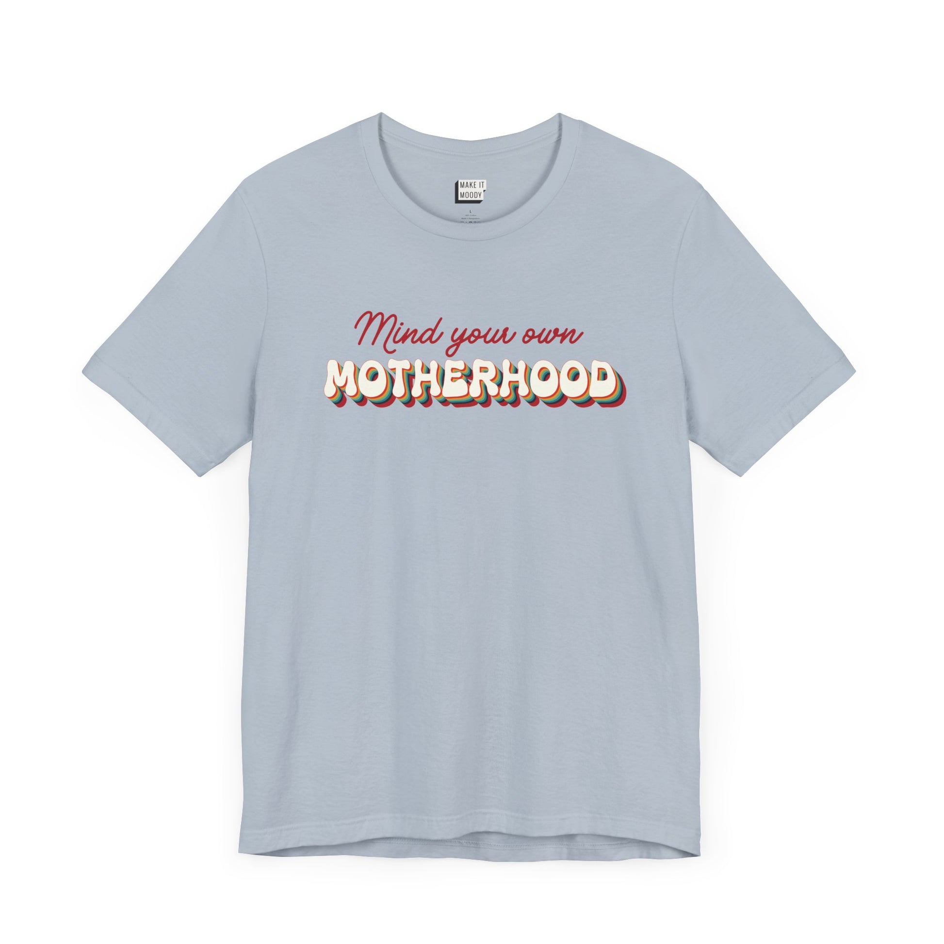 Light blue mom t-shirt featuring the text Mind your own MOTHERHOOD in red and rainbow-colored 3D-style retro letters.