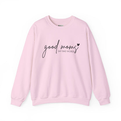 Pink Mom Sweatshirt with the words GOOD MOMS in black cursive and the words SAY BAD WORDS in print text with a black heart detail.