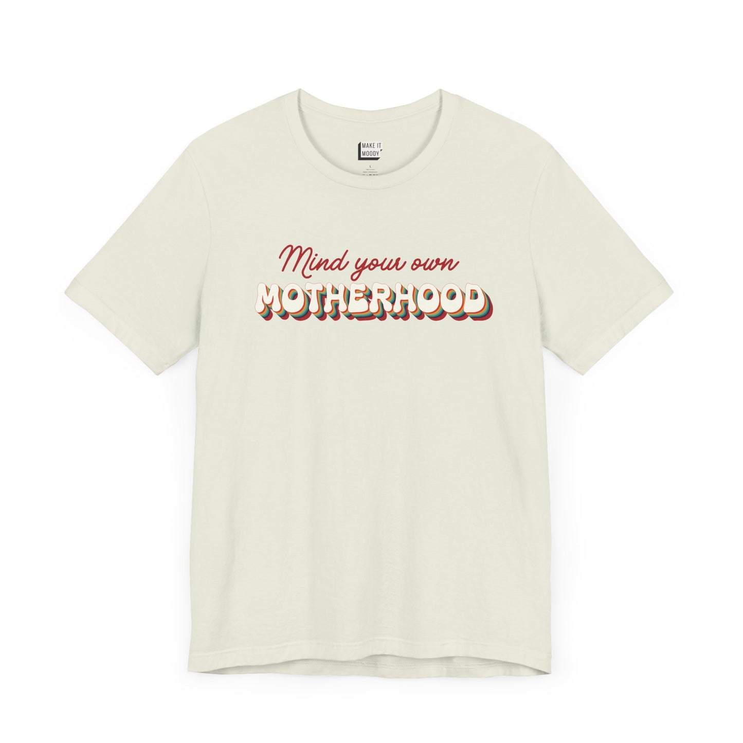 Light green mom t-shirt featuring the text Mind your own MOTHERHOOD in red and rainbow colored 3D-style retro letters.