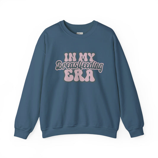 Denim blue breastfeeding sweatshirt that says IN MY BREASTFEEDING ERA in pink and blue retro lettering.