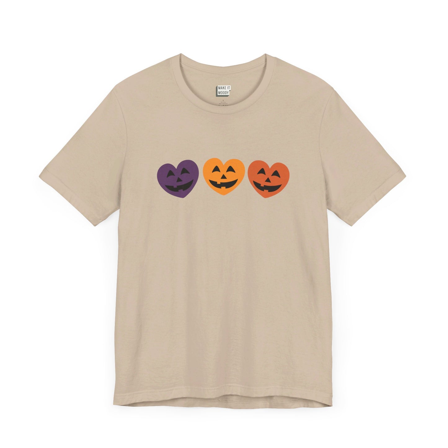 tan halloween shirt with 3 heat shaped jack-o-lantern faces on the front