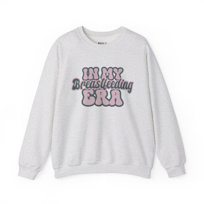 Ash colored breastfeeding sweatshirt that says IN MY BREASTFEEDING ERA in pink and blue retro lettering.