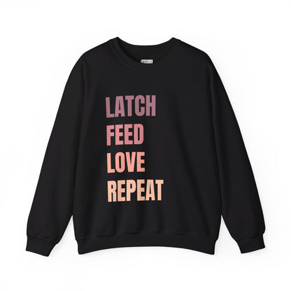 Black breastfeeding sweatshirt that says LATCH FEED LOVE REPEAT in bold pink gradient font.