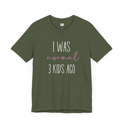 Military green Mom t-shirt with the text I Was Normal 3 Kids Ago printed in white and pink.