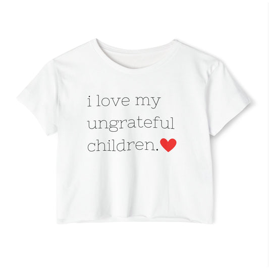 Mom crop top in white featuring the words i love my ungrateful children in black lowercase courier font, with a small red heart icon at the end of the text.