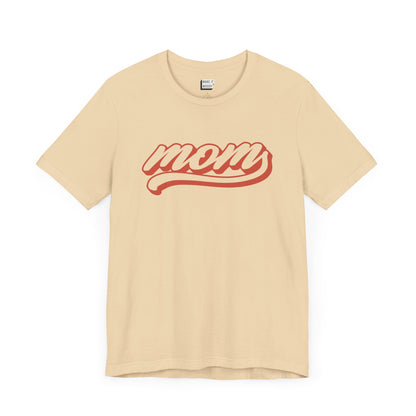 Soft cream baseball style mom t-shirt with the word MOM written in red cursive text.