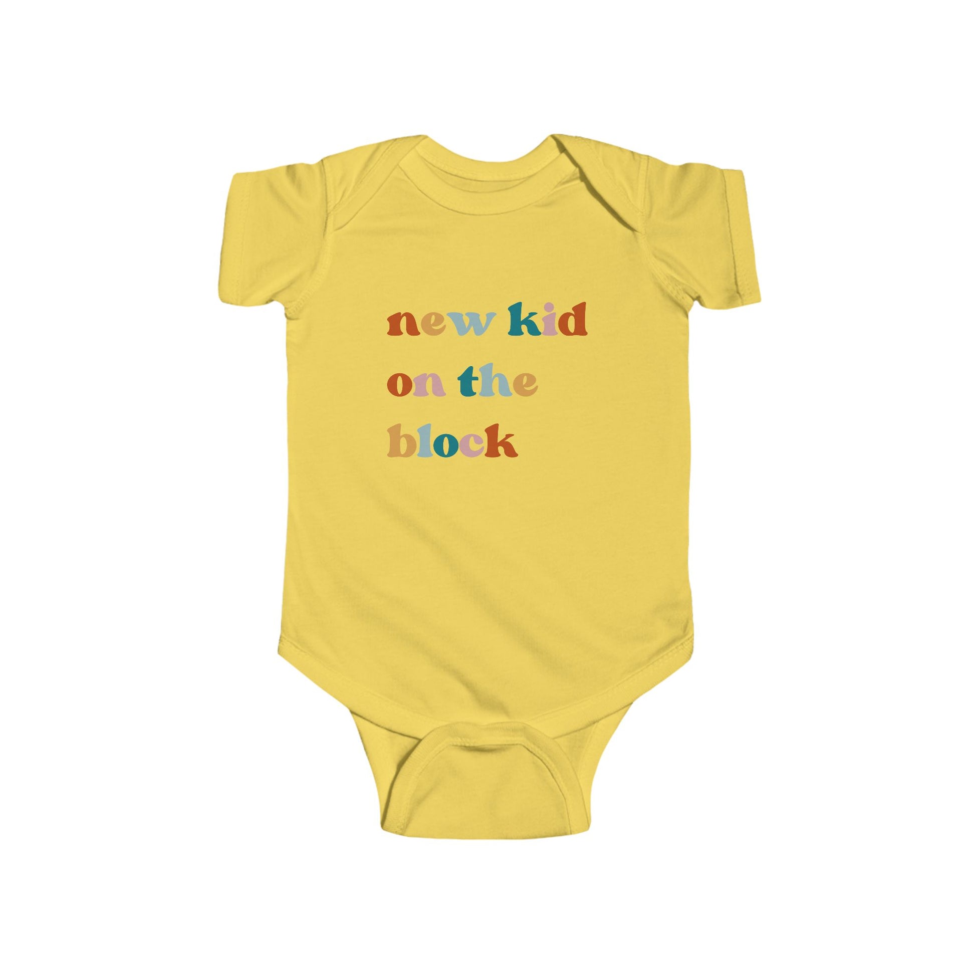 Yellow infant bodysuit that says 'NEW KID ON THE BLOCK in multicolored font.