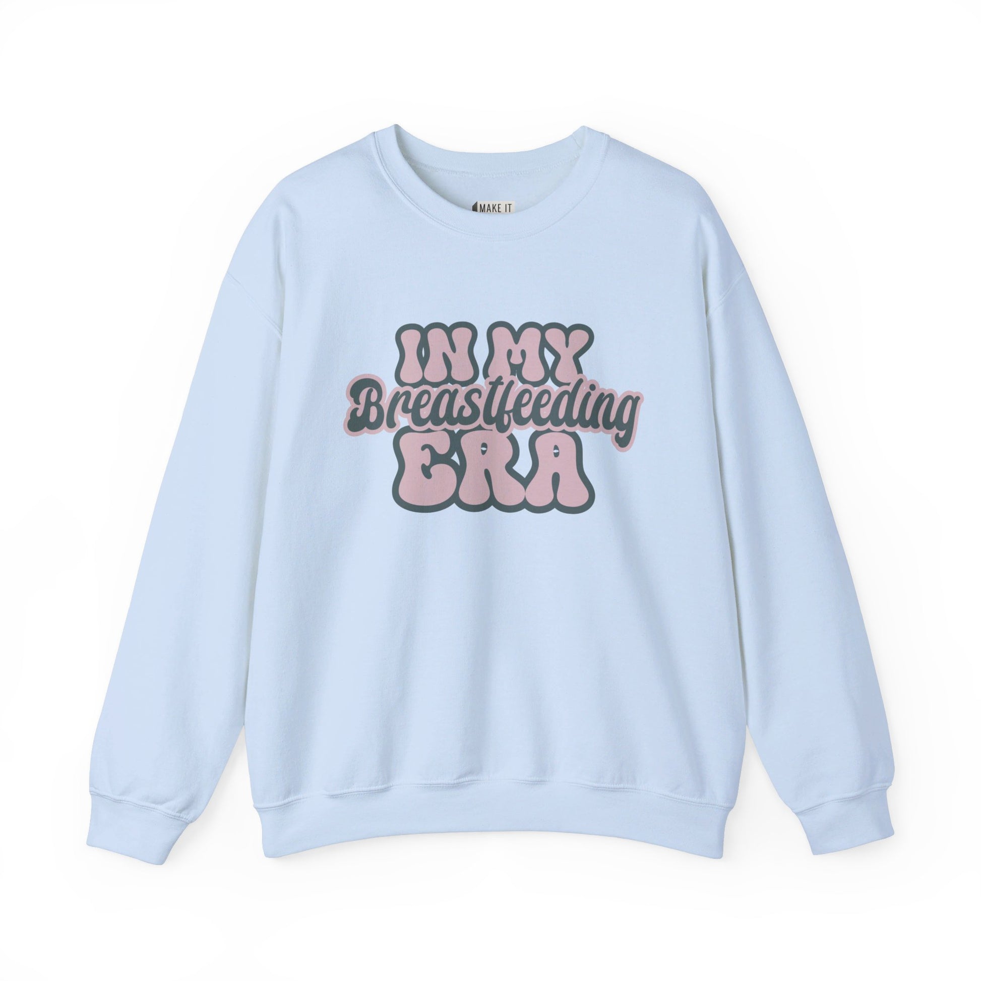 Light blue breastfeeding sweatshirt that says IN MY BREASTFEEDING ERA in pink and blue retro lettering.