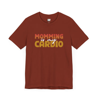 Rust colored mom t-shirt featuring the text Momming is my Cardio in red, yellow, and white fonts.