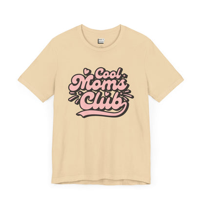 Soft cream mom t-shirt that says cool moms club in pink and black retro font.