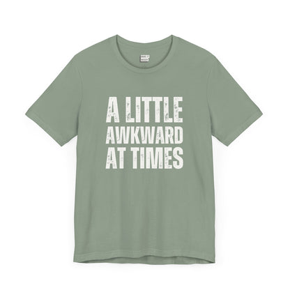 funny t shirt in sage green that says A LITTLE AWKWARD AT TIMES in bold white lettering