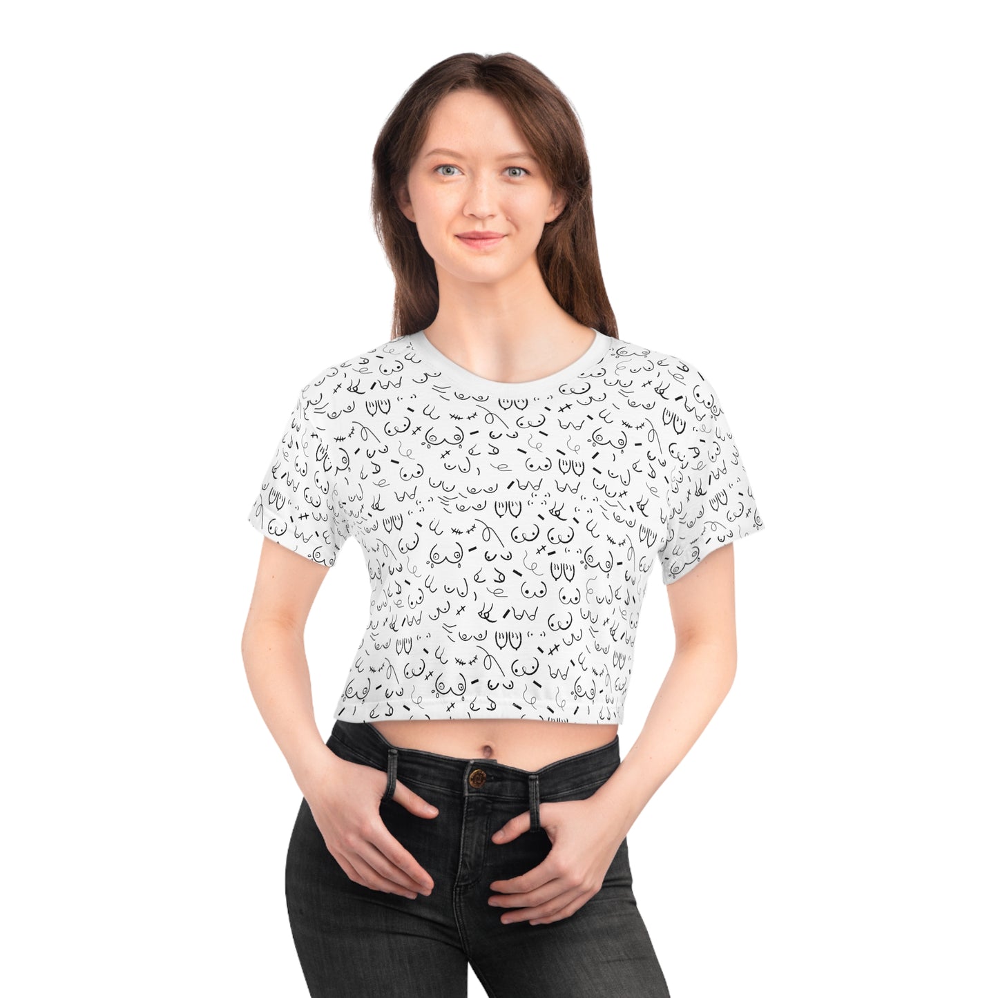 A proud breastfeeding mom with long brown hair wears the Boob Pattern Cropped Breastfeeding Tee, a white t-shirt featuring a black line pattern, paired with dark jeans, smiling confidently.