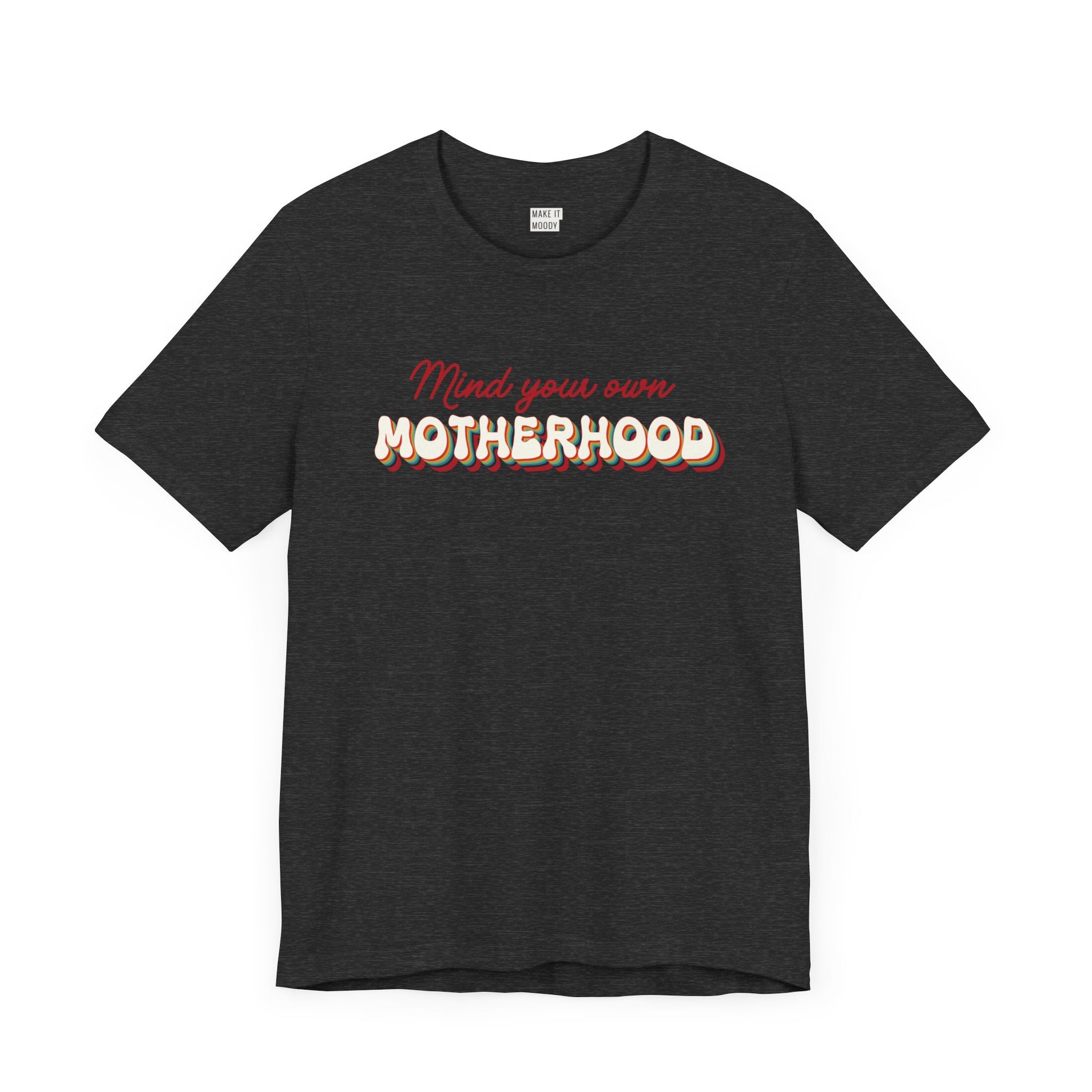 Dark heather grey mom t-shirt featuring the text Mind your own MOTHERHOOD in red and rainbow-colored 3D-style retro letters.