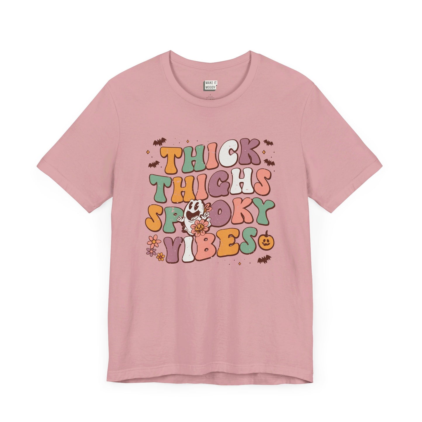 pink halloween t-shirt that says, thick thighs spooky vibes in colorful retro lettering