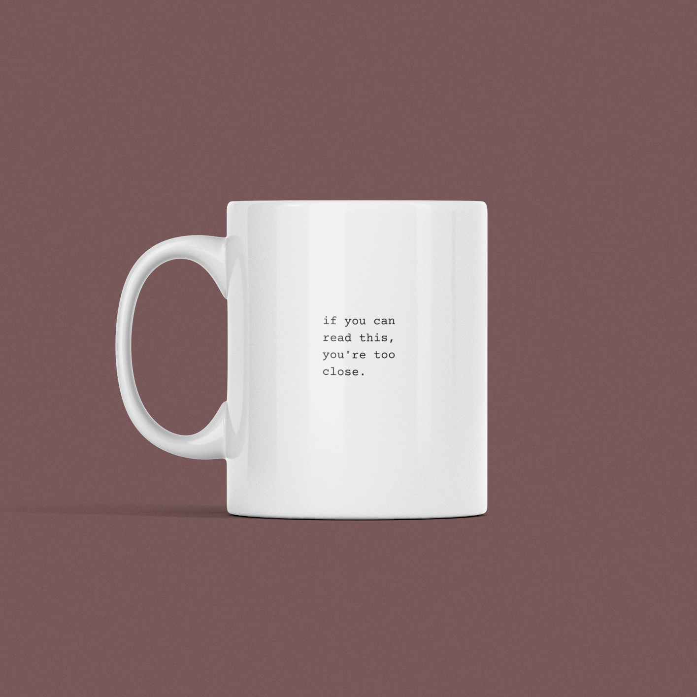 The "If You Can Read This Mug" features a white design set against a solid brown backdrop, emblazoned with the phrase "if you can read this, you're too close.