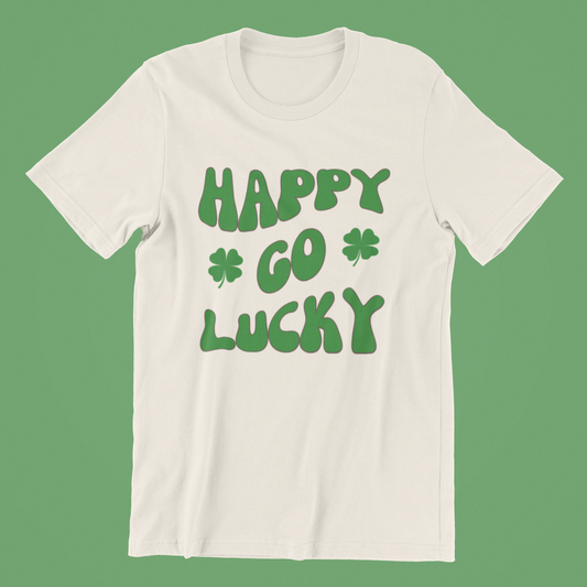 Happy Go Lucky Tee featuring the phrase "HAPPY GO LUCKY" in green bubbly text and two shamrocks on a vibrant green background.